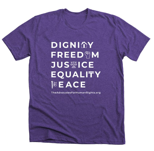 purple t-shirt with white text that reads "dignity, freedom, justice, equality, peace"