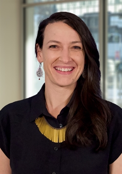 three-quarter portrait of Lindsey in dark shirt and gold necklace